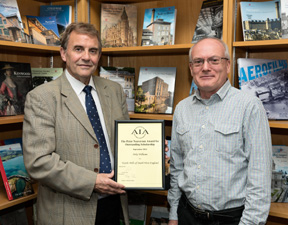 Retired English Heritage senior manager Keith Falconer presenting Mike Williams (English Heritage) with an award for the 'Textile Mills of South West England' book.